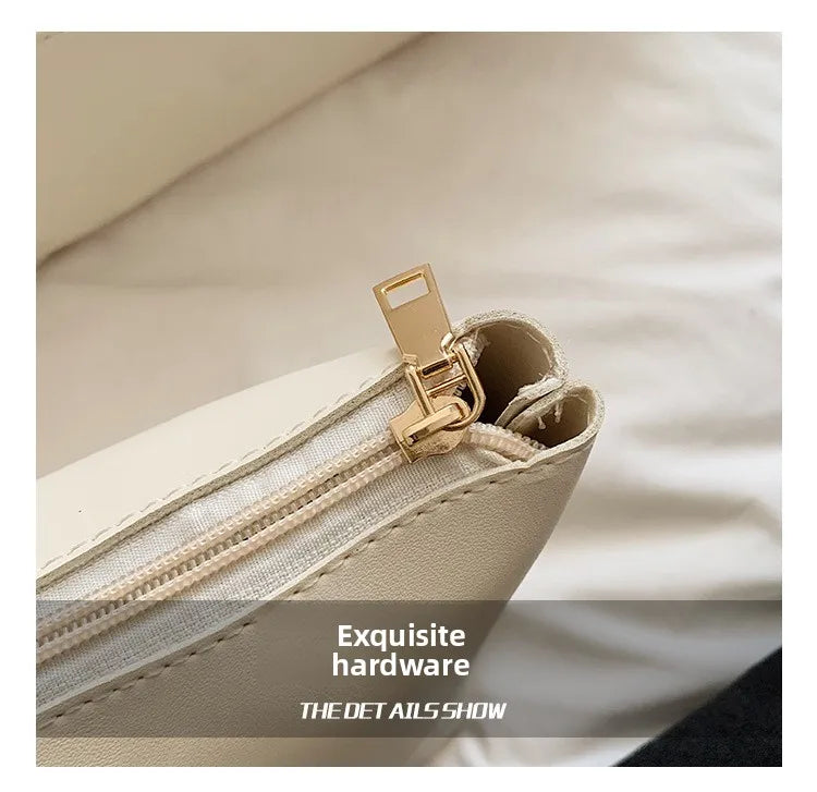 Close-up of a light beige straw woven tote bag showing exquisite gold hardware and PU trim detail.