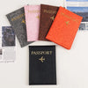 A collection of five passport holders in various colors and leopard print textures, including pink, brown, black, and orange.