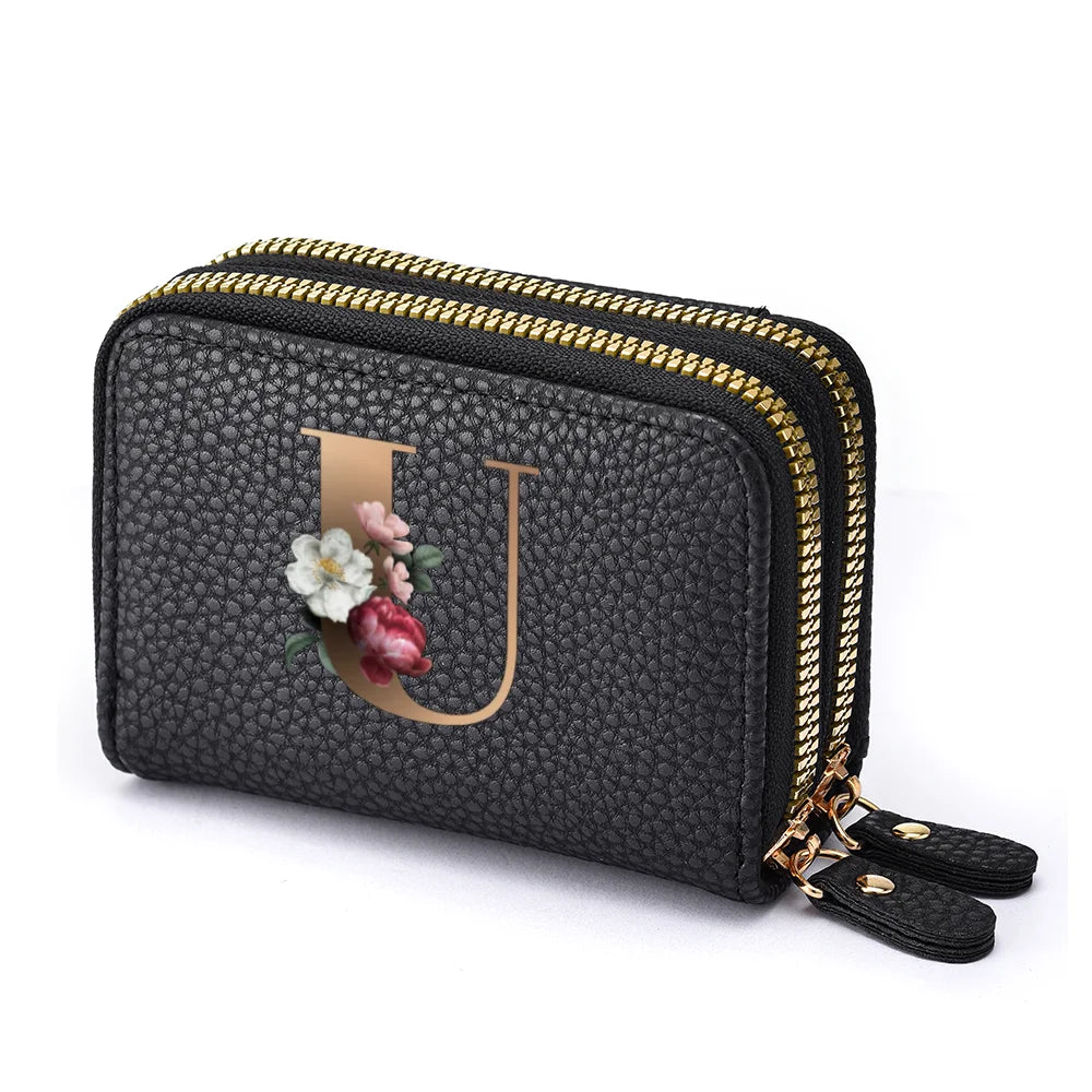 Black floral letter print mini wallet with a gold zipper and leather strap