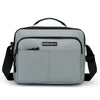A gray professional waterproof men's business briefcase with black straps and a leather tag.