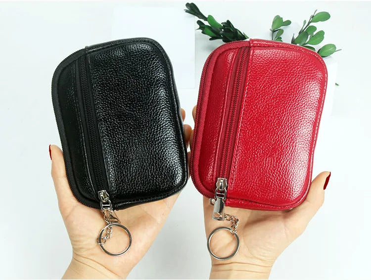 A hand holds a compact black and red PU leather mini wallet with a silver keychain.