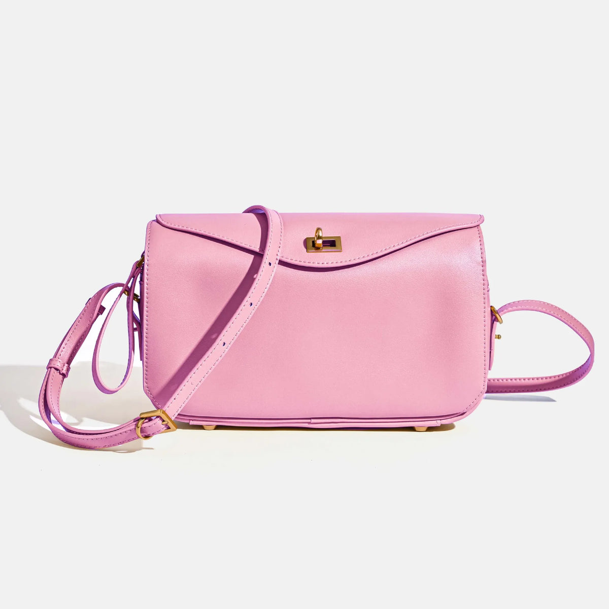 A pink genuine leather square shoulder crossbody bag with gold hardware.