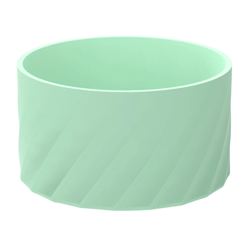 A light mint green silicone boot sleeve designed to fit water bottles.
