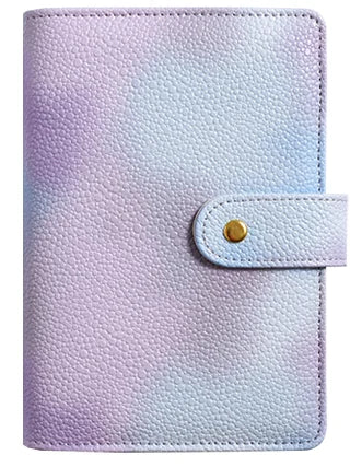 A purple and white marbled leather ring binder notebook with a light blue elastic closure.