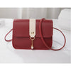 A maroon fashion square crossbody bag with a light beige strap and gold chain detail.