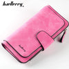 A pink velvet card holder wallet with a zipper closure and a black trim is shown on a white background.