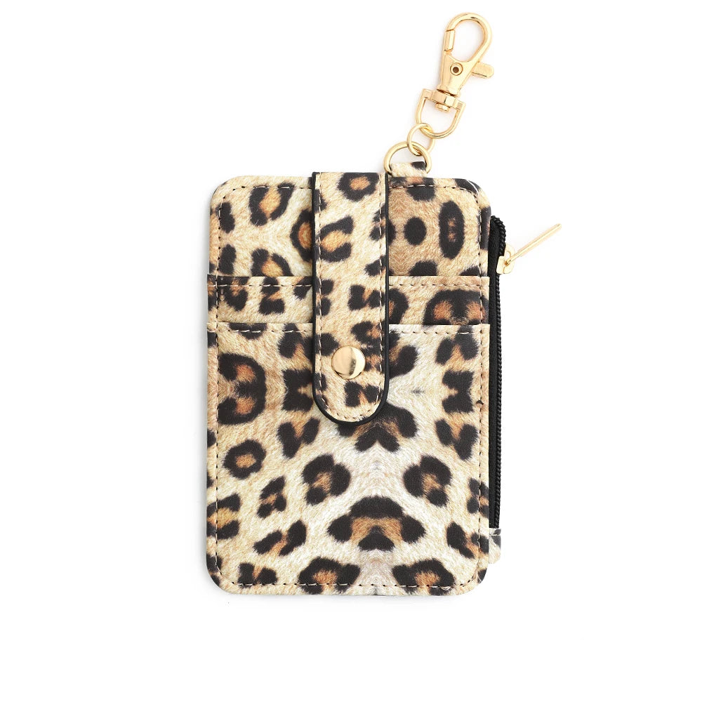 A small leopard print silicone PU leather key chain wristlet wallet with a gold-tone chain.