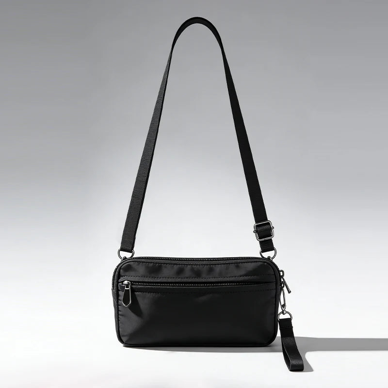 Black premium zipper phone pouch with a black wrist strap shown against a light gray background.