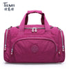 A magenta nylon travel duffle bag with zippered compartments and handles.