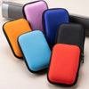 A collection of colorful PU hard cases for portable SSDs, including orange, purple, blue, and red.