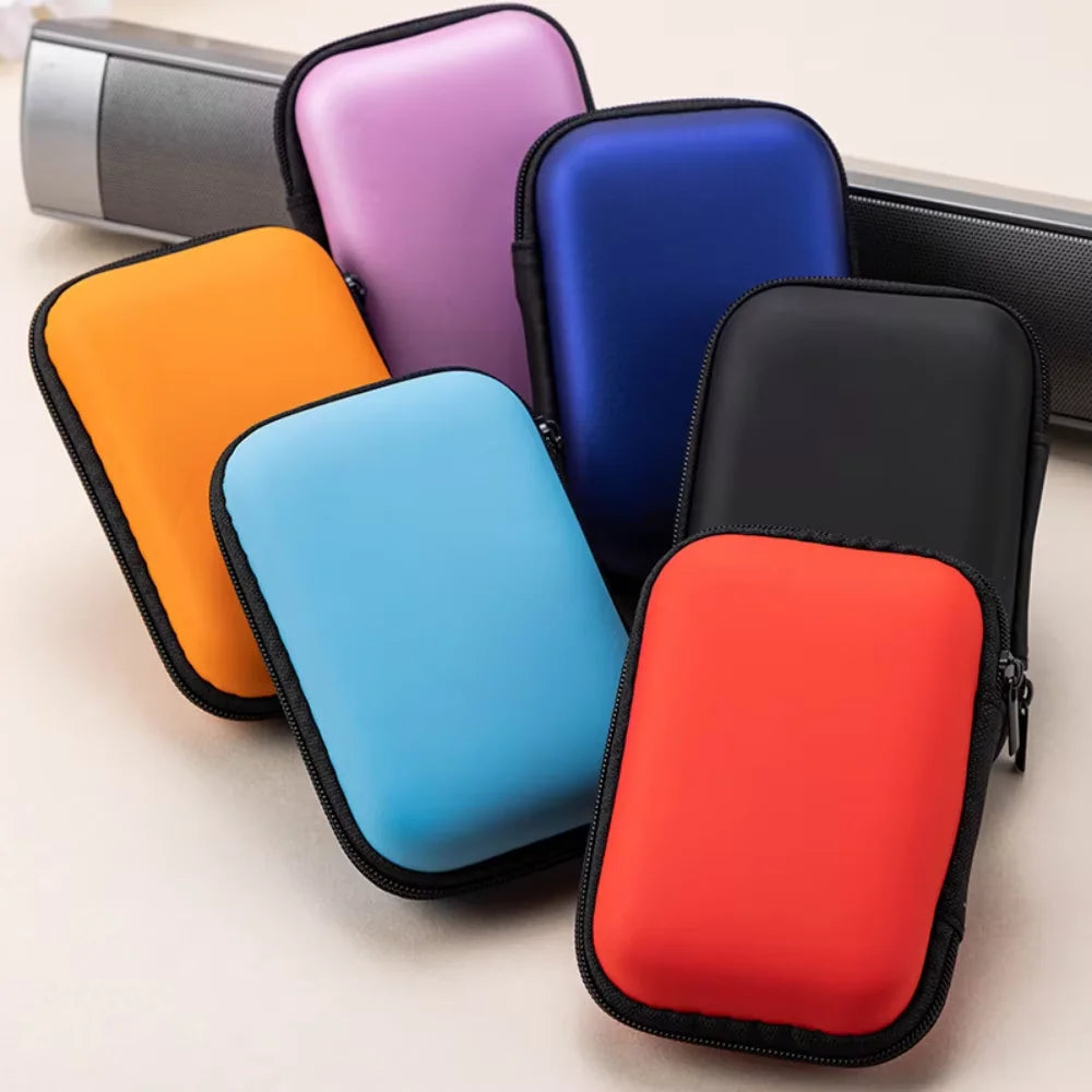 A collection of colorful PU hard cases for portable SSDs, including orange, purple, blue, and red.