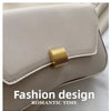 A close-up of a light beige leather crossbody bag featuring gold hardware and a soft, elegant design.
