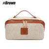 A beige and brown leather travel toiletry bag with a handle and zipper closure.