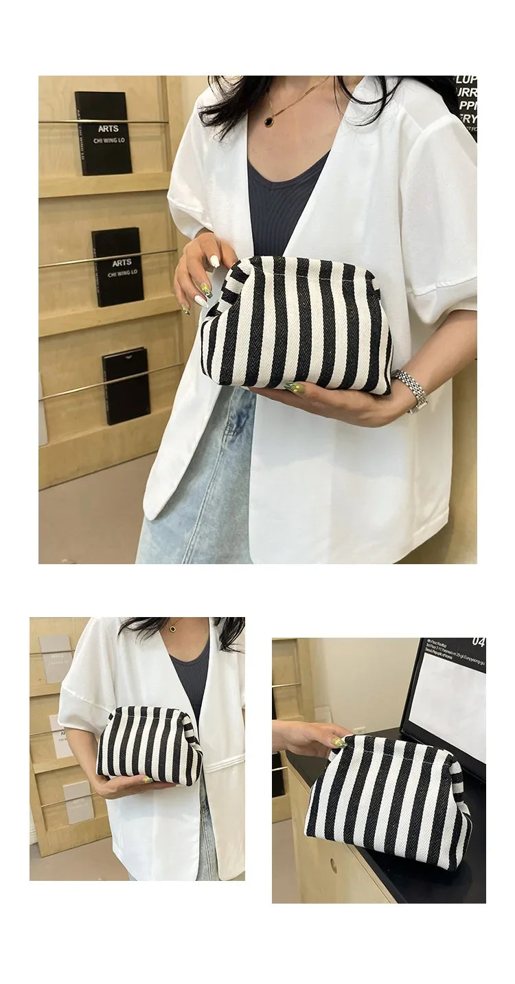 A woman holds a black and white striped crochet tote bag with a shell accent in a light-colored shirt.