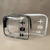 A clear plastic toiletry bag with icons for a plane, suitcase, and toiletries.