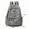 A leopard print laptop backpack with padded straps shown from the front.
