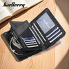 A black leather card holder wallet with a clear window displaying cards and a pen, resting on a wooden surface.