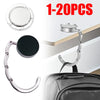 Gancho plegable plateado con clip circular y gancho curvo, mostrado contra un bolso de cuero.