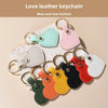 A collection of new and fashionable leather heart keychains in various pastel colors like mint green, pink, white, black, and