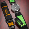 A black nylon sport strap with a green accent is shown alongside a Garmin watch.