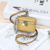 A handcrafted yellow leather coin purse with a zipper is displayed on a map and next to a book.