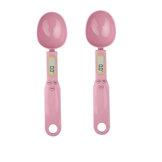 A pair of pink precision digital kitchen scales with round weighing bowls.