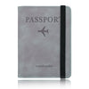 A grey leather passport travel wallet with a black strap and a silver airplane icon.