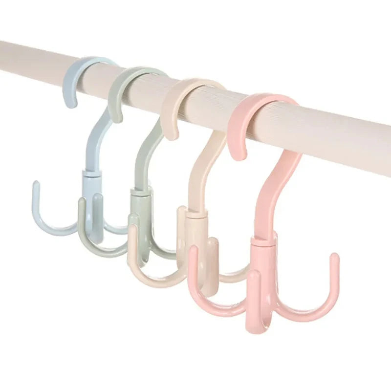 A set of four multi-functional hanging hooks in pastel colors, including light blue, mint green, beige, and pink.