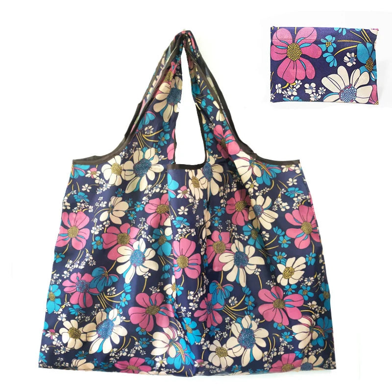 A floral patterned canvas tote shopping bag featuring pink, blue, and white flowers.