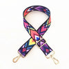 Sangle ajustable colorée à motifs pour sacoche, avec des dessins géométriques violets, roses et jaunes.
