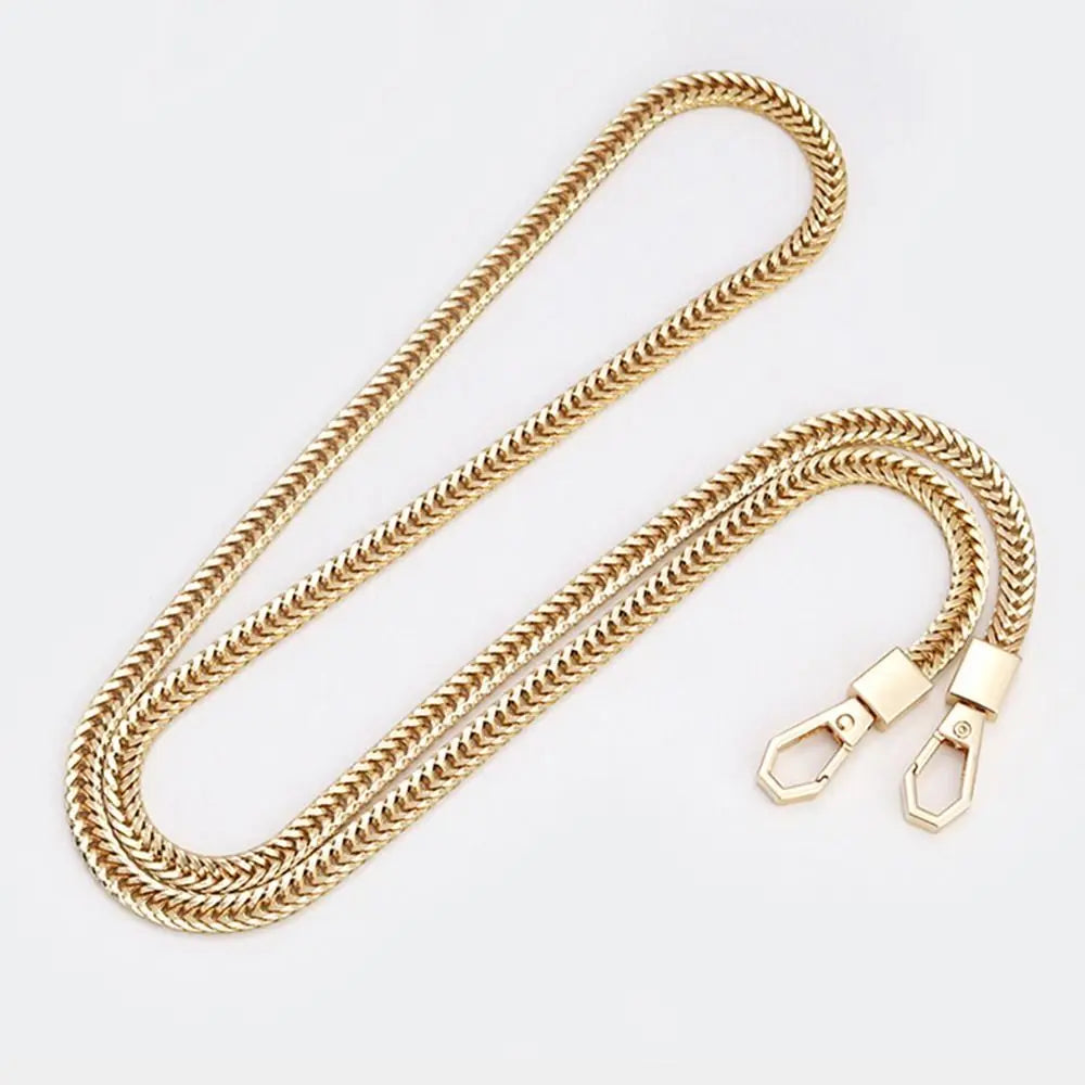 A gold-colored metal bag chain strap with a textured link design, shown laid out on a white background.