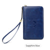 A navy blue leather passport holder with a lanyard and an embossed globe design.