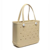 A beige portable EVA beach tote bag with a perforated design and light brown handles.