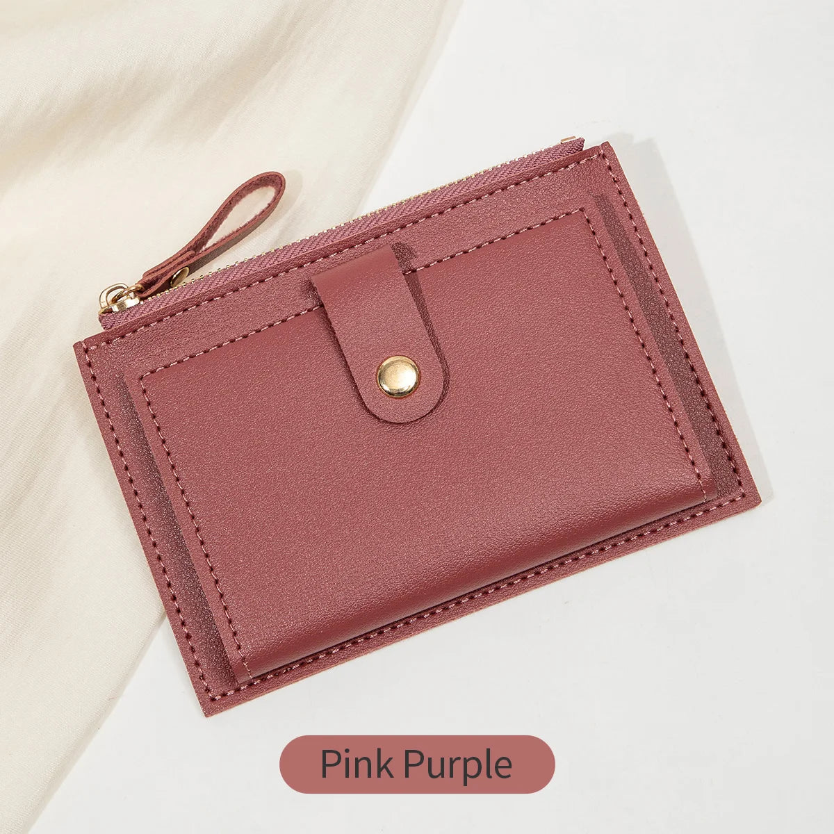 A pink purple ultra-thin PU leather card holder wallet with a stitched edge and a leather strap.