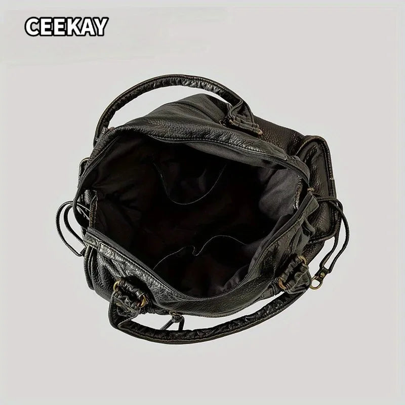 A black vintage washed leather tote bag with a handle shown from the interior.