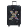 A black rolling suitcase with a dark patterned stretch fabric protection cover.