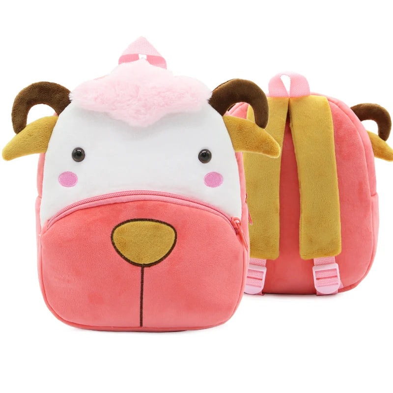 A pink cartoon animal plush backpack shaped like a lion face with brown ears and a white muzzle.