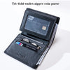 A black tri-fold wallet with a zipper closure showing a leather card slot and a clear plastic window.