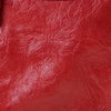 A close-up view of a deep red soft PU leather shoulder tote bag.