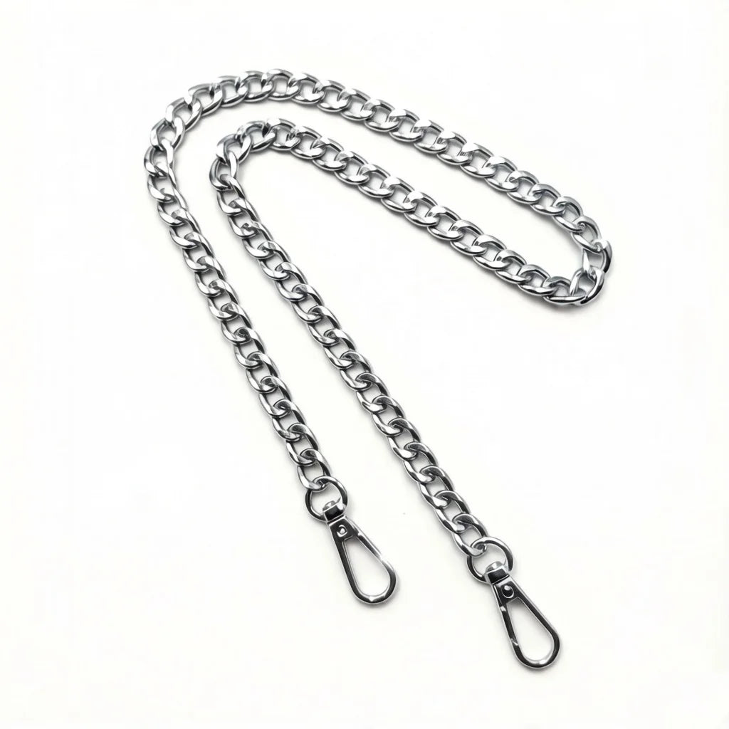 A silver metal chain crossbody strap laid out on a white background.
