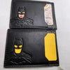 A black leather card holder featuring a Batman logo design with a yellow accent.