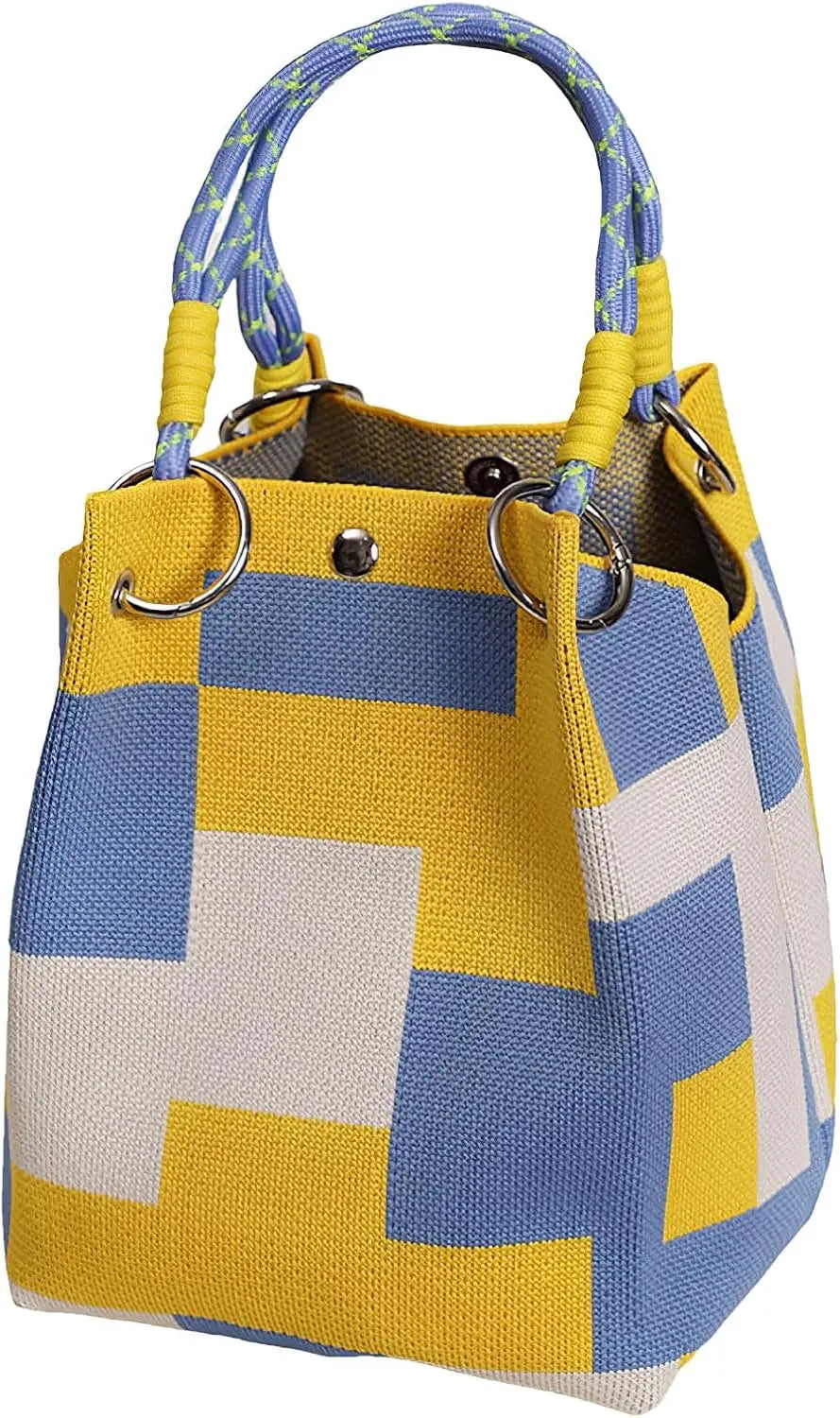 A yellow and blue geometric colorblock knitted bucket bag with woven handles.