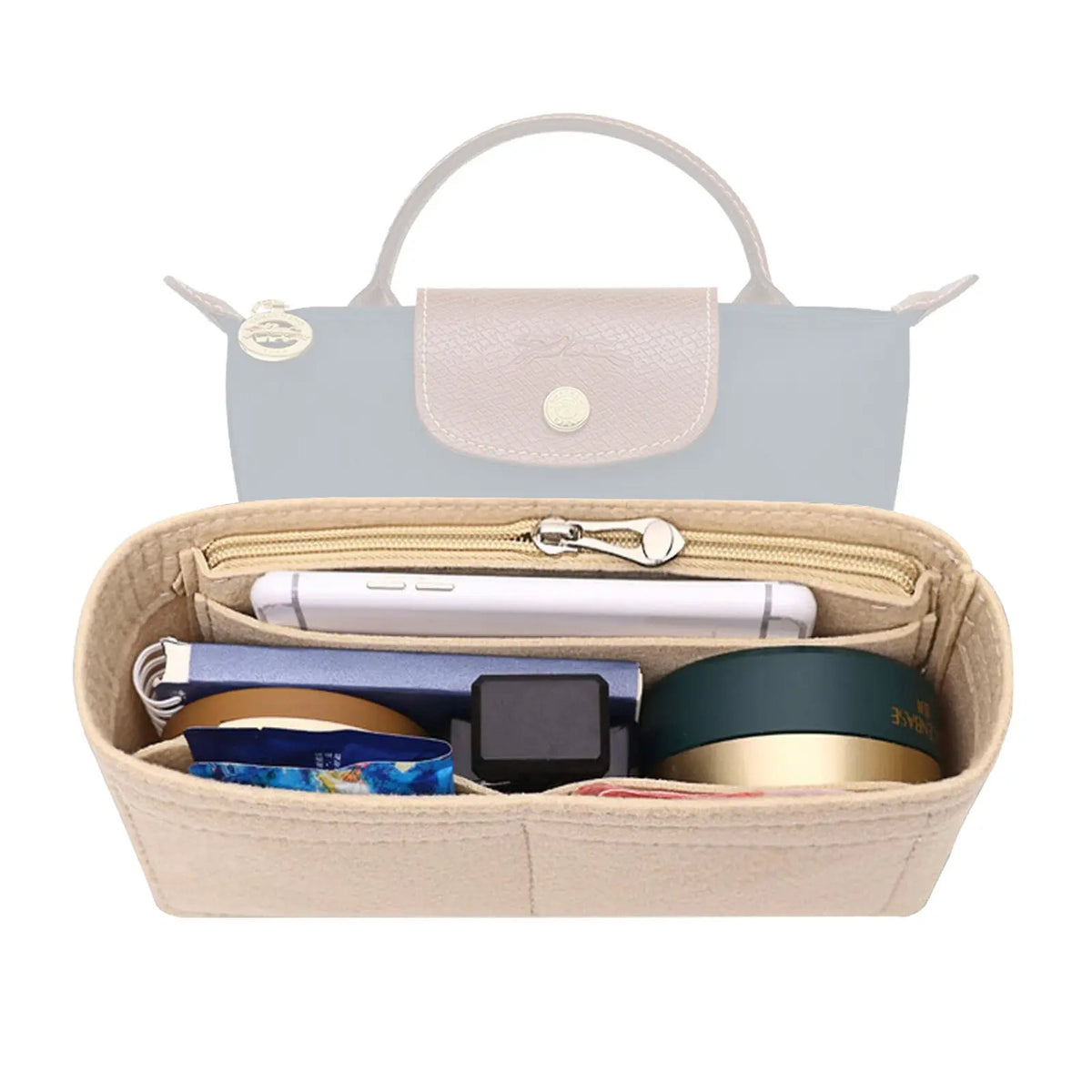 A light beige felt organizer insert for a handbag, showing various small accessories inside.