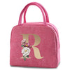 A pink insulated canvas lunch bag featuring a large gold letter R with floral accents.