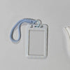 A white card holder with a clear plastic cover and a light blue lanyard attached.