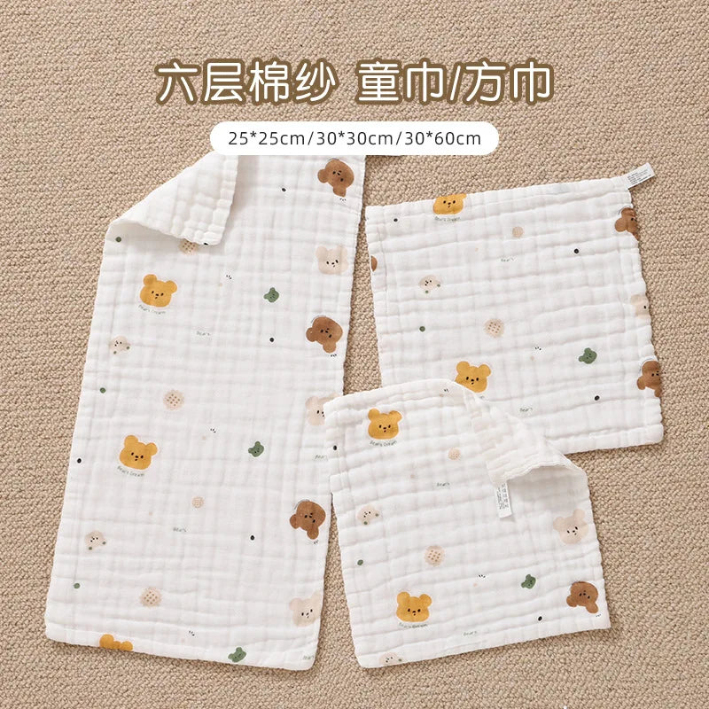 White muslin baby burp cloth towels in various sizes, including a long piece and a smaller square.