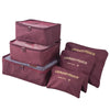 A set of three maroon laundry pouches or packing cubes for travel organization.