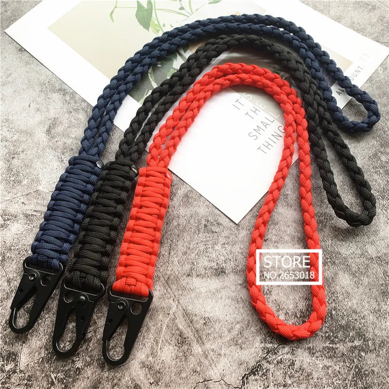 Hand-woven nylon lanyards in blue, black, and red with metal hooks displayed on a white background.