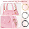 Close-up view of a pink handbag showing various metal key ring clips and buckles used as bag chain components.