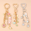 Gold and silver jewelry featuring a seashell starfish charm with pearl accents on a chain.